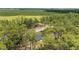 Aerial shot of a home surrounded by lush trees and greenery, offering privacy and seclusion at 23964 Nw Falcon Ave, Dunnellon, FL 34431