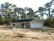 Charming single-story home with a two-car garage and landscaped front yard at 23964 Nw Falcon Ave, Dunnellon, FL 34431