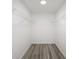 Walk-in closet with wire shelving and wood-look flooring offering a simple storage solution at 23964 Nw Falcon Ave, Dunnellon, FL 34431