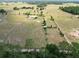 Expansive aerial view of horse property featuring perimeter fencing, paddocks and lush surroundings at 258 Nw 122Nd Ave, Oxford, FL 34484