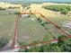 Expansive aerial view of horse property featuring perimeter fencing and lush surroundings at 258 Nw 122Nd Ave, Oxford, FL 34484