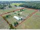 Expansive aerial view of horse property featuring perimeter fencing, paddocks and lush surroundings at 258 Nw 122Nd Ave, Oxford, FL 34484