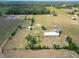 Expansive aerial view of horse property featuring fenced paddocks, a round pen, a home, and lush surroundings at 258 Nw 122Nd Ave, Oxford, FL 34484