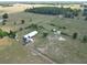 Expansive aerial view of horse property featuring fenced paddocks, a round pen, a home, and lush surroundings at 258 Nw 122Nd Ave, Oxford, FL 34484