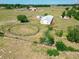 Expansive aerial view of horse property featuring fenced paddocks, a round pen, a home, and lush surroundings at 258 Nw 122Nd Ave, Oxford, FL 34484