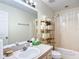 Bathroom featuring a well-lit mirror and vanity next to a shower and toilet at 258 Nw 122Nd Ave, Oxford, FL 34484