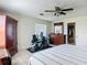 Bright bedroom with dark wood furniture, ceiling fan, neutral walls, and tile flooring at 258 Nw 122Nd Ave, Oxford, FL 34484