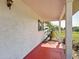Covered porch with views of the yard and fencing at 258 Nw 122Nd Ave, Oxford, FL 34484
