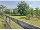 A rustic wooden fence surrounds a lush green pasture at 258 Nw 122Nd Ave, Oxford, FL 34484