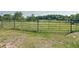 View of the green metal frame of a horse corral on a large plot with grass at 258 Nw 122Nd Ave, Oxford, FL 34484