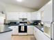 Bright kitchen featuring white cabinets, green countertops, and modern appliances at 258 Nw 122Nd Ave, Oxford, FL 34484