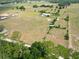 Expansive aerial view of horse property featuring perimeter fencing and lush surroundings at 258 Nw 122Nd Ave, Oxford, FL 34484