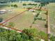 Expansive aerial view of horse property featuring perimeter fencing and lush surroundings at 258 Nw 122Nd Ave, Oxford, FL 34484