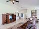 Open-concept living room with view of kitchen area, tile floor and natural light at 258 Nw 122Nd Ave, Oxford, FL 34484