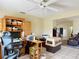 Open office area featuring tile flooring and a large wooden desk with plenty of shelving and storage at 258 Nw 122Nd Ave, Oxford, FL 34484