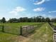View of a pasture enclosed by wooden and metal fence at 258 Nw 122Nd Ave, Oxford, FL 34484