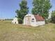Shed with red roofing, white siding, and a green lawn at 258 Nw 122Nd Ave, Oxford, FL 34484