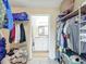 Walk-in closet with wire shelving and clothes, leading to the bathroom at 258 Nw 122Nd Ave, Oxford, FL 34484