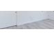 Bedroom features light, wood-look floors, white walls, and two white doors at 2627 Sw 154Th Place Rd, Ocala, FL 34473