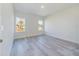 Bedroom with wood-look floors and large windows providing lots of natural light at 2627 Sw 154Th Place Rd, Ocala, FL 34473