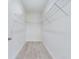Walk-in closet with white walls, wood-look floors, and built-in wire shelving at 2627 Sw 154Th Place Rd, Ocala, FL 34473