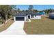 Well-designed exterior with an attached garage, concrete driveway, and manicured lawn at 2627 Sw 154Th Place Rd, Ocala, FL 34473