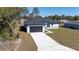Charming one-story home featuring a two-car garage and a modern design with gray paint and a concrete driveway at 2627 Sw 154Th Place Rd, Ocala, FL 34473