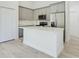Kitchen with white island, stainless appliances, and gray cabinets at 2627 Sw 154Th Place Rd, Ocala, FL 34473