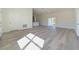 Bright and airy living room featuring wood-look floors that flow into an open kitchen at 2627 Sw 154Th Place Rd, Ocala, FL 34473