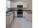 Modern kitchen featuring white cabinets, stainless steel appliances, and sleek countertops at 267 Oak Lane Trak, Ocala, FL 34472