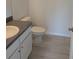 Clean bathroom features a modern vanity with granite countertop and neutral tile flooring at 2803 Sw 147Th Ct, Ocala, FL 34481