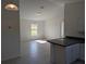 Sunlit living room showcases an open layout with an adjacent kitchen at 2803 Sw 147Th Ct, Ocala, FL 34481