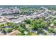 Aerial view of a city neighborhood featuring tree-lined streets and commercial buildings in the distance at 426 Sw 13Th St, Ocala, FL 34471