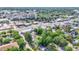 Wide aerial shot of neighborhood with many trees surrounding homes and busy commercial streets nearby at 426 Sw 13Th St, Ocala, FL 34471