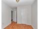 A bedroom with hardwood floors and white walls has two doors to access the room and a centered overhead light at 426 Sw 13Th St, Ocala, FL 34471
