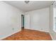 A bedroom with hardwood floors and white walls has two doors to access the room and a centered overhead light at 426 Sw 13Th St, Ocala, FL 34471