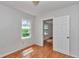 A bedroom with hardwood floors and white walls has two doors to access the room and a centered overhead light at 426 Sw 13Th St, Ocala, FL 34471