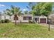 Cozy single-story home featuring a well-manicured lawn, palm tree, and attached garage, offering comfortable suburban living at 426 Sw 13Th St, Ocala, FL 34471