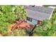 Wooden deck nestled in a lush, tropical setting with surrounding trees, creating a private outdoor space at 426 Sw 13Th St, Ocala, FL 34471
