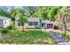 Charming home featuring a well-manicured lawn and a cozy, inviting facade, complemented by lush, mature trees at 426 Sw 13Th St, Ocala, FL 34471