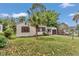 Lovely single-story home with a well-kept lawn, prominent palm tree, and attached garage, exemplifying suburban charm at 426 Sw 13Th St, Ocala, FL 34471
