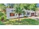 Inviting single-story home with a tidy lawn, mature palm tree, and attached garage, offering a cozy and welcoming curb appeal at 426 Sw 13Th St, Ocala, FL 34471