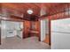 The kitchen has wood paneling, white cabinets, a stove, and a small table with a refrigerator to the side at 426 Sw 13Th St, Ocala, FL 34471