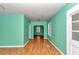Bright living room with wood laminate flooring, white trim, and neutral walls at 426 Sw 13Th St, Ocala, FL 34471