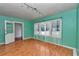 Living room featuring hardwood floors, a light fixture, and white trim at 426 Sw 13Th St, Ocala, FL 34471