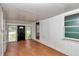 Bright sunroom features wood floors, a black front door, and white paneled walls at 426 Sw 13Th St, Ocala, FL 34471