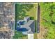 Aerial view of the house, highlighting the roof, privacy fence, backyard, and long driveway at 4314 Se 131St Ln, Belleview, FL 34420