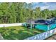 Beautiful backyard with an enclosed porch, grassy yard, a privacy fence and blue exterior at 4314 Se 131St Ln, Belleview, FL 34420