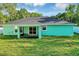 Nice backyard featuring a grassy area, privacy fence, blue exterior, and an enclosed porch at 4314 Se 131St Ln, Belleview, FL 34420