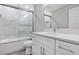Beautifully remodeled bathroom features a white quartz vanity and marble shower at 4314 Se 131St Ln, Belleview, FL 34420